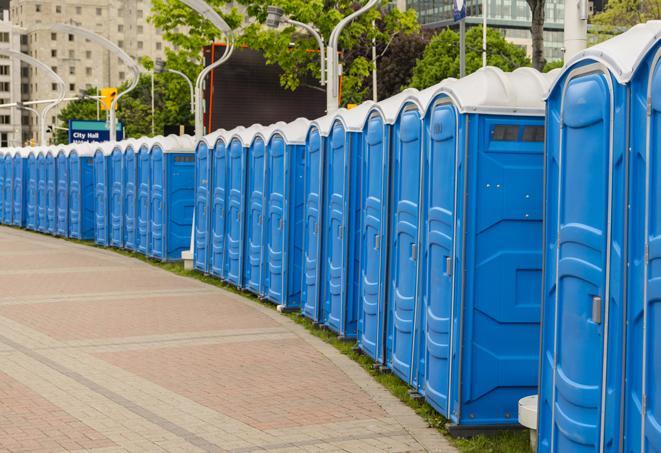 a clean row of portable restrooms for outdoor weddings or festivals in Caruthers